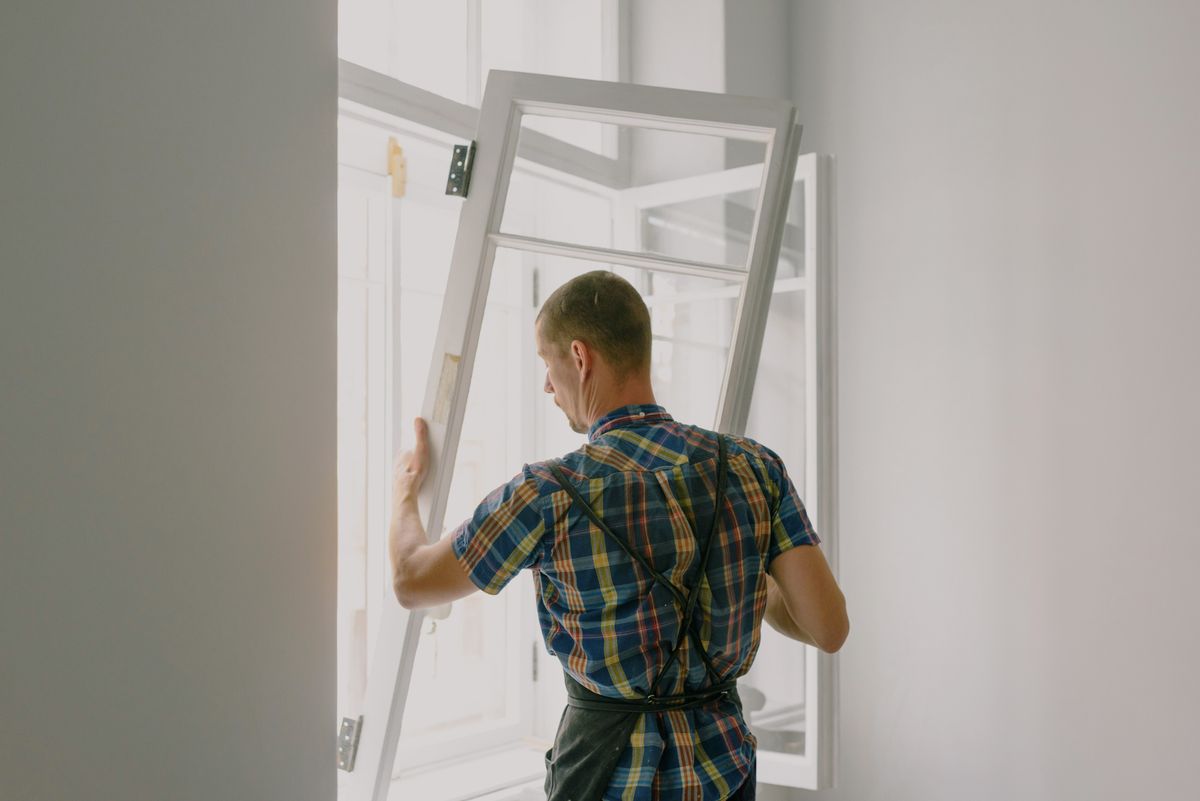 Installer fitting a new window